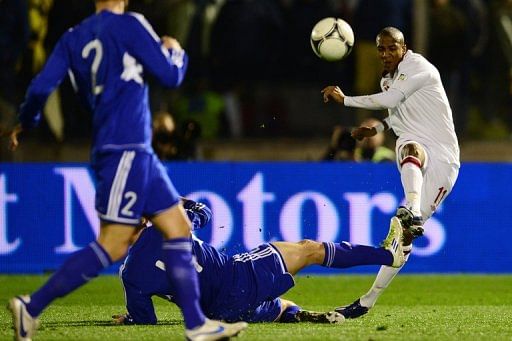 England's Ashley Young shots past San Marino's Alex Gasperoni in their World Cup 2014 qualifying match March 22, 2013